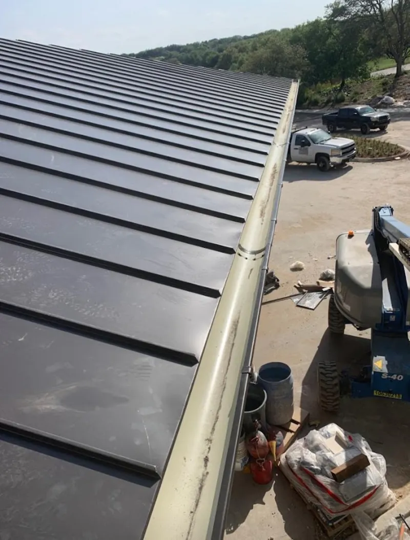 Standing seam panel and gutter detail on a metal roofing jobsite in Marshall